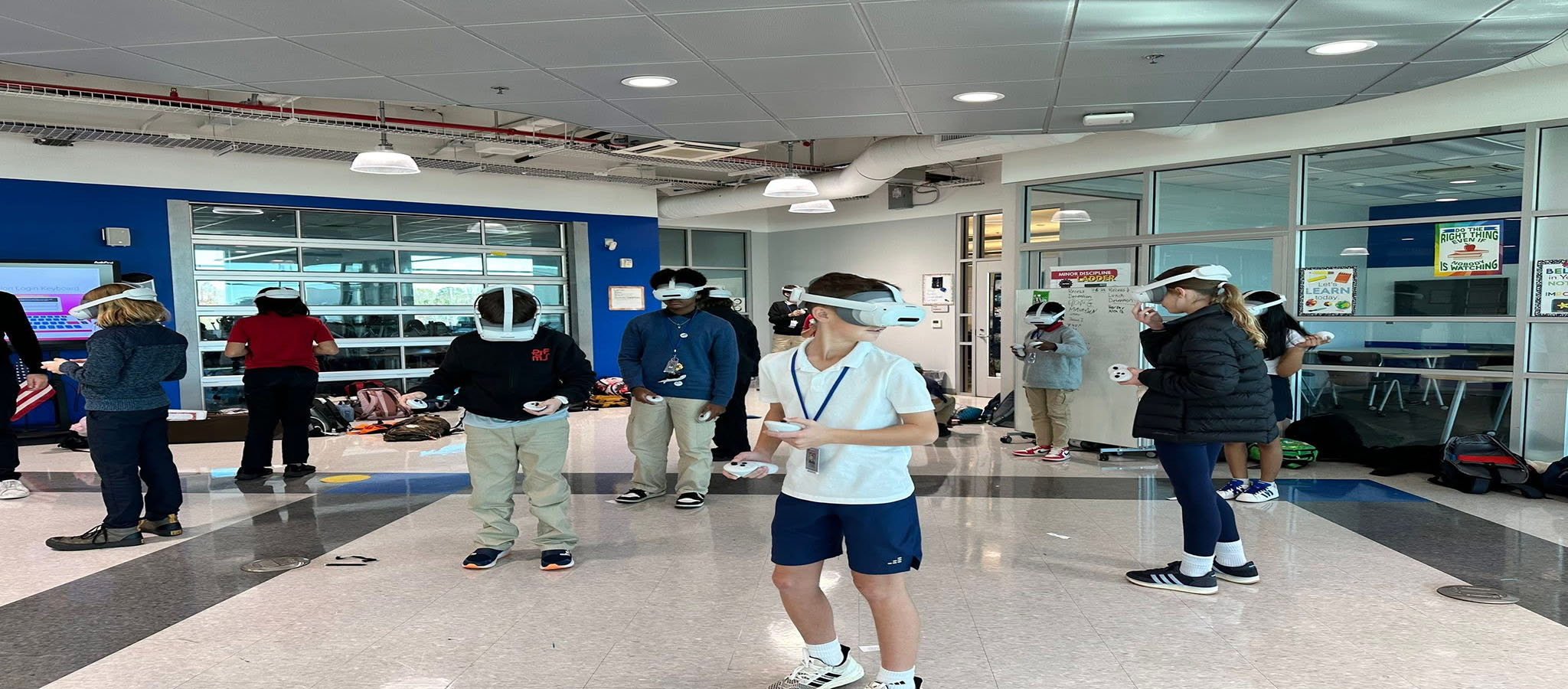 students standing  using VR Goggles to do math